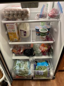 opened fridge full of fruits and vegetables