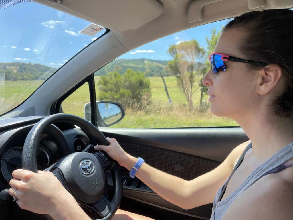 Kate driving on the right hand side of a car with great concentration