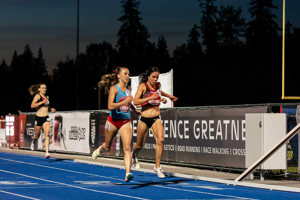 Kate chasing after other athletes at the end of a 5,000m race.